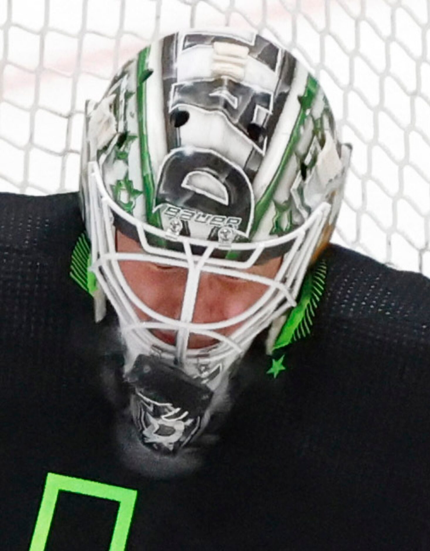 Dallas Stars goaltender Jake Oettinger (29) takes a shot to the face mask during the third...