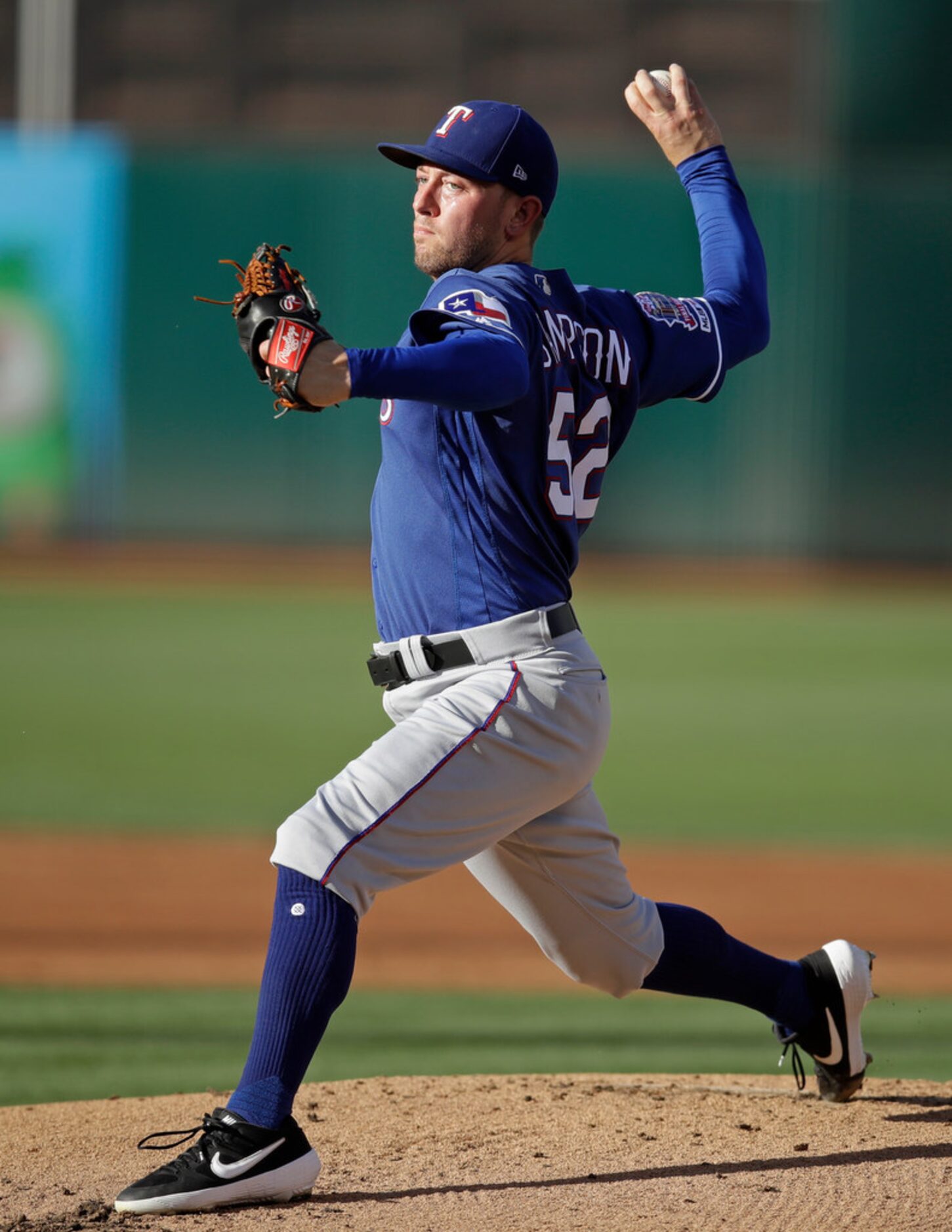 Texas Rangers pitcher Adrian Sampson works against the Oakland Athletics in the first inning...