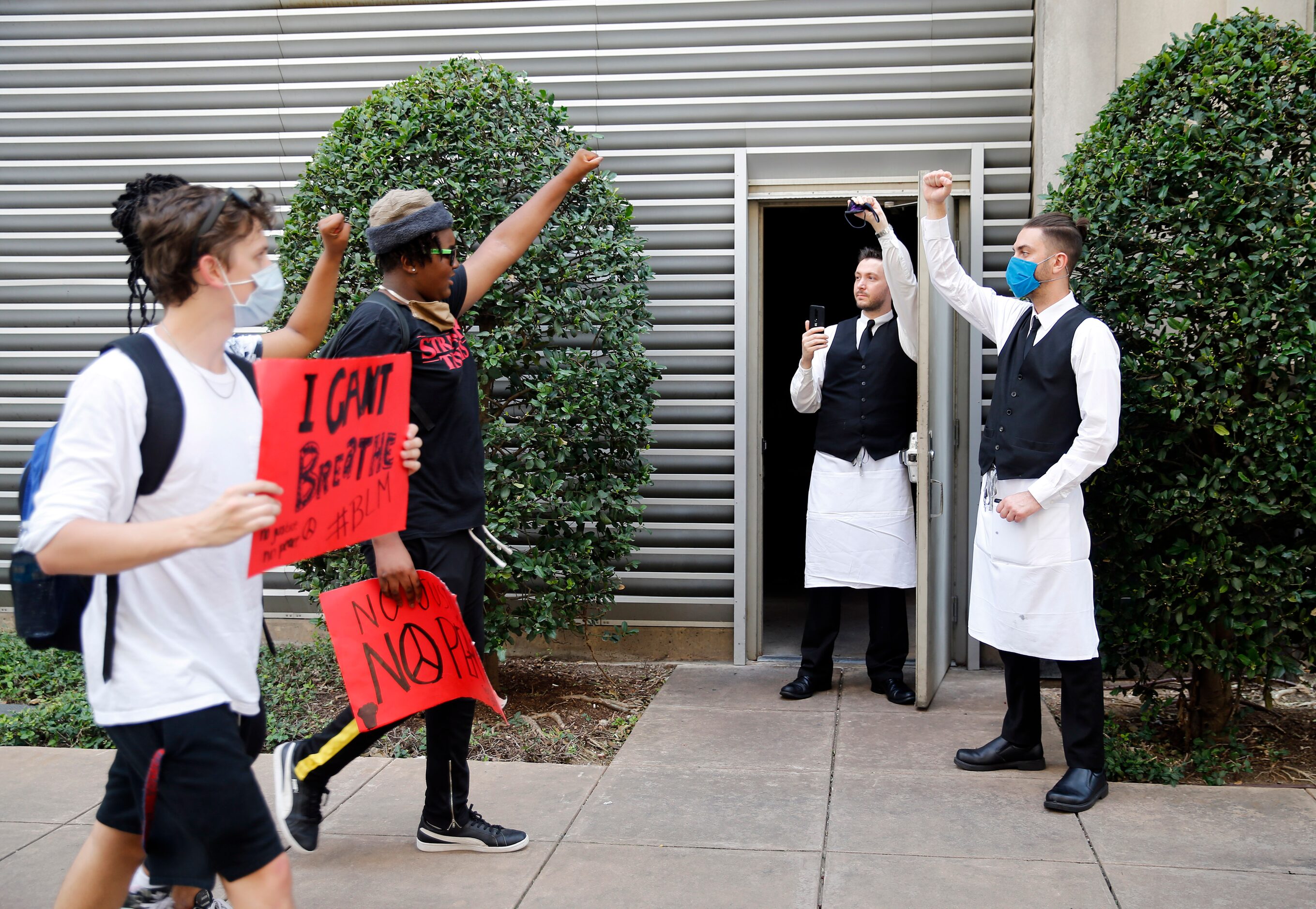 Employees of Perry's Steakhouse and Grill (right) came out of the restaurant in solidarity...