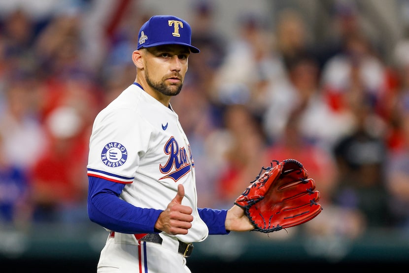 Texas Rangers starting pitcher Nathan Eovaldi (17) gives a thumbs up after being hit by a...