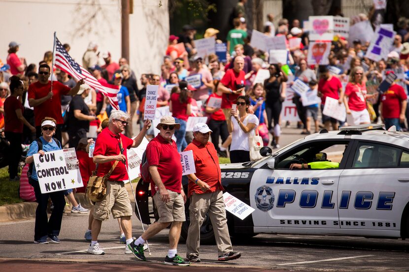 Dallas police block traffic as demonstrators march down Young Street near City Hall.