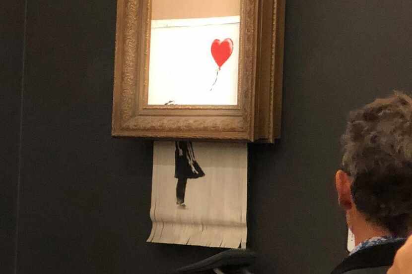 In a photo provided by Sotheby's, the moment when Banksy's Girl With Balloon was destroyed...