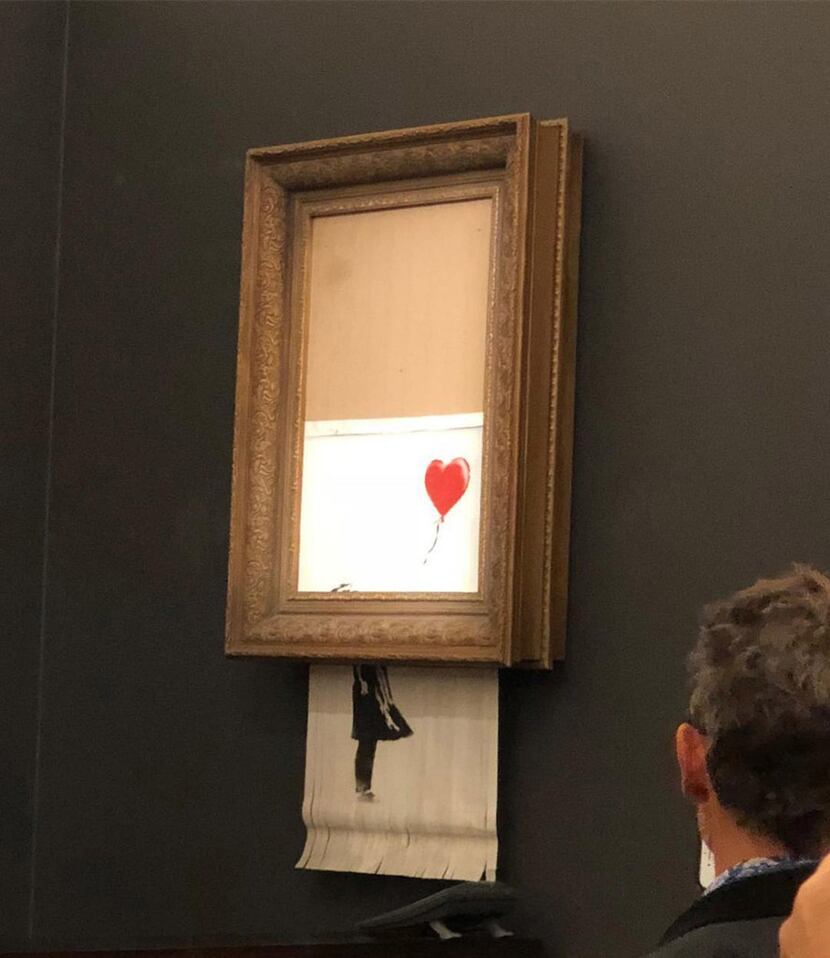 In a photo provided by Sotheby's, the moment when Banksy's Girl With Balloon was destroyed...