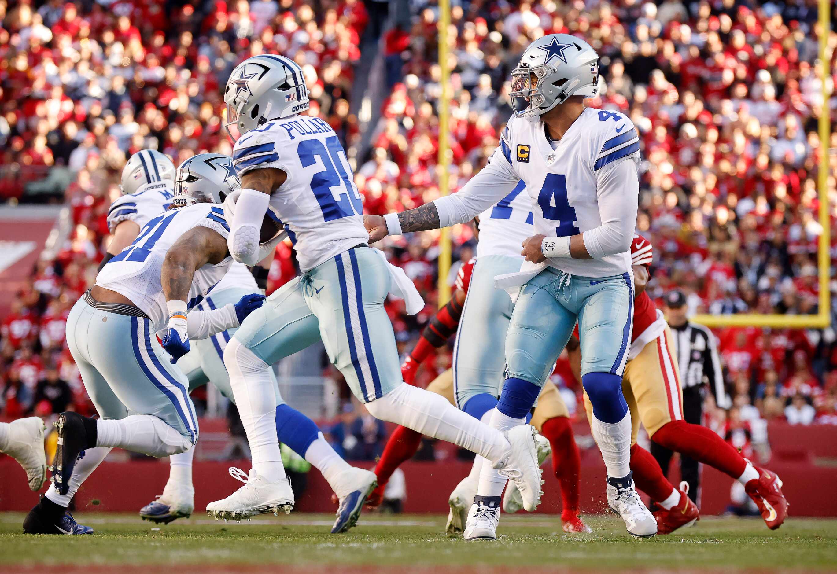 Dallas Cowboys quarterback Dak Prescott (4) hands the ball off to Dallas Cowboys running...