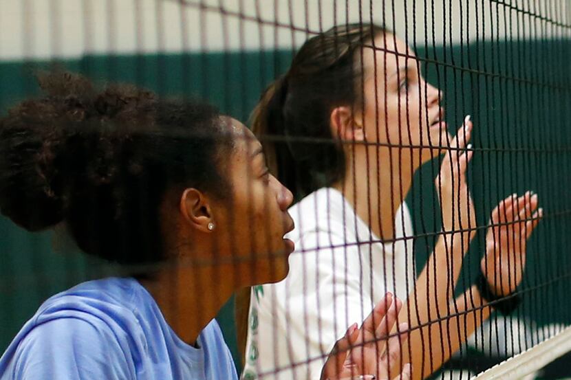 Kennedale varsity volleyball teammates Alex Youngblood, left, and Bryley Steinhilber wait...