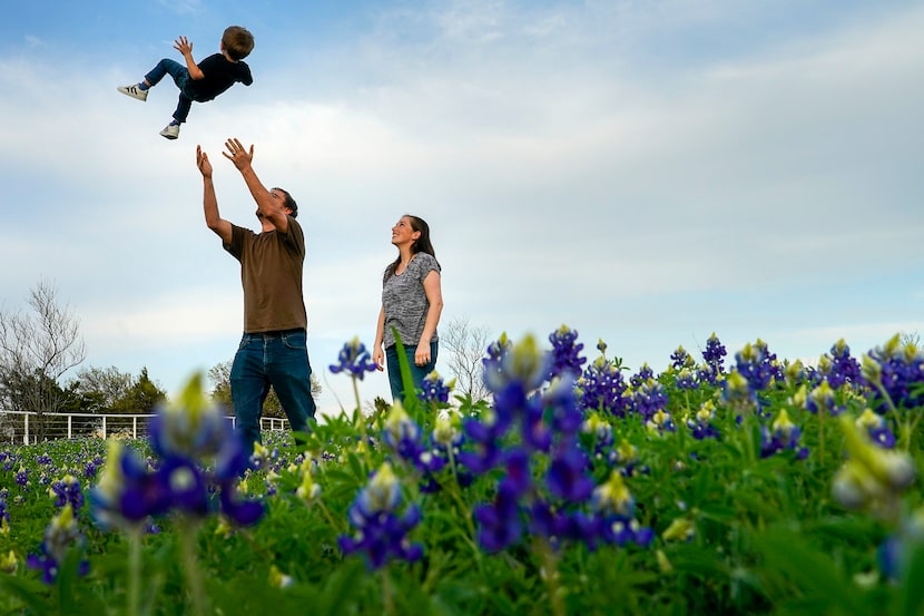 John Wallace tossed his son Ryan, 3, into the air as he and his wife Kim, stood in a field...