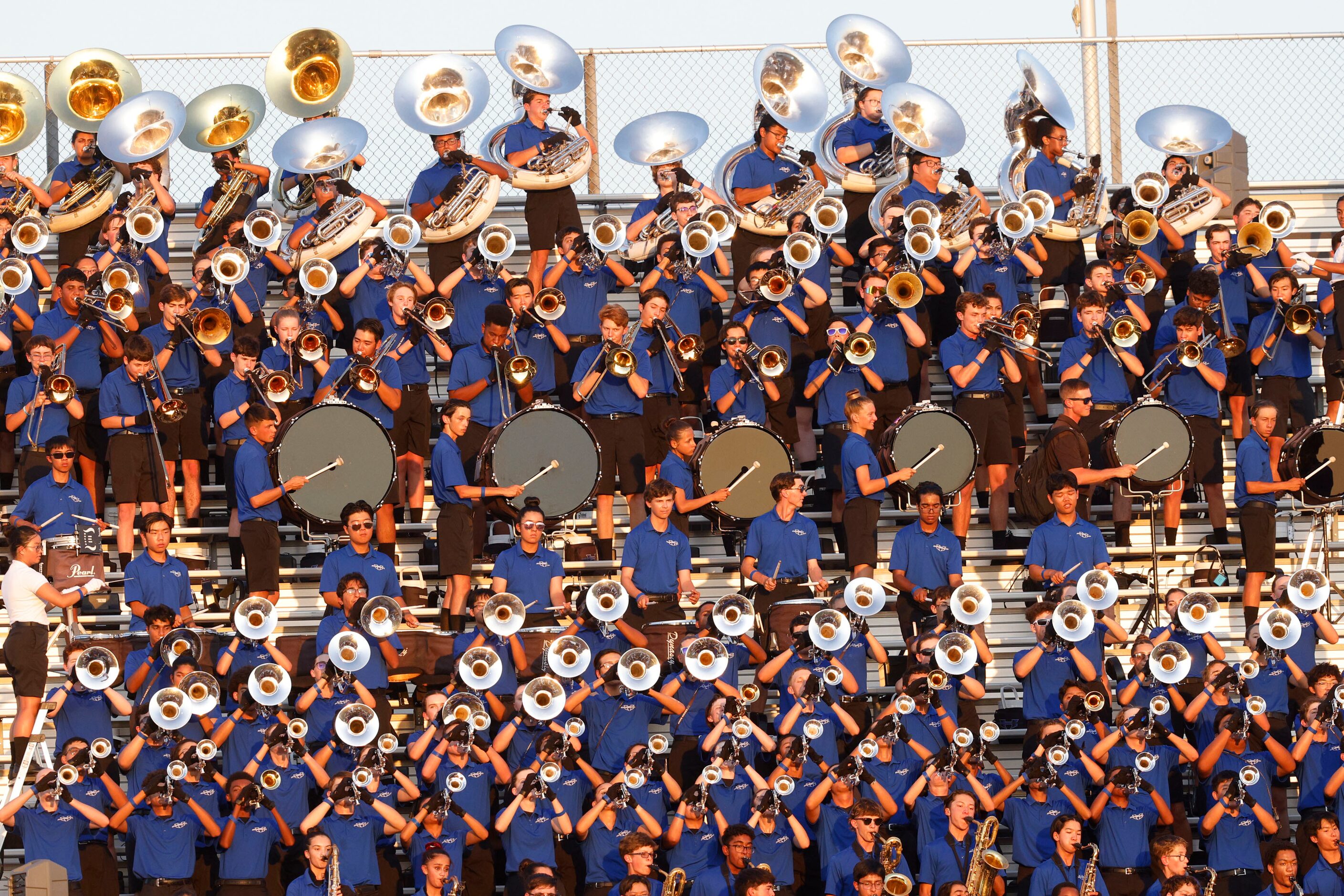 Hebron’s marching band members perform before a high school football game against Lancaster,...