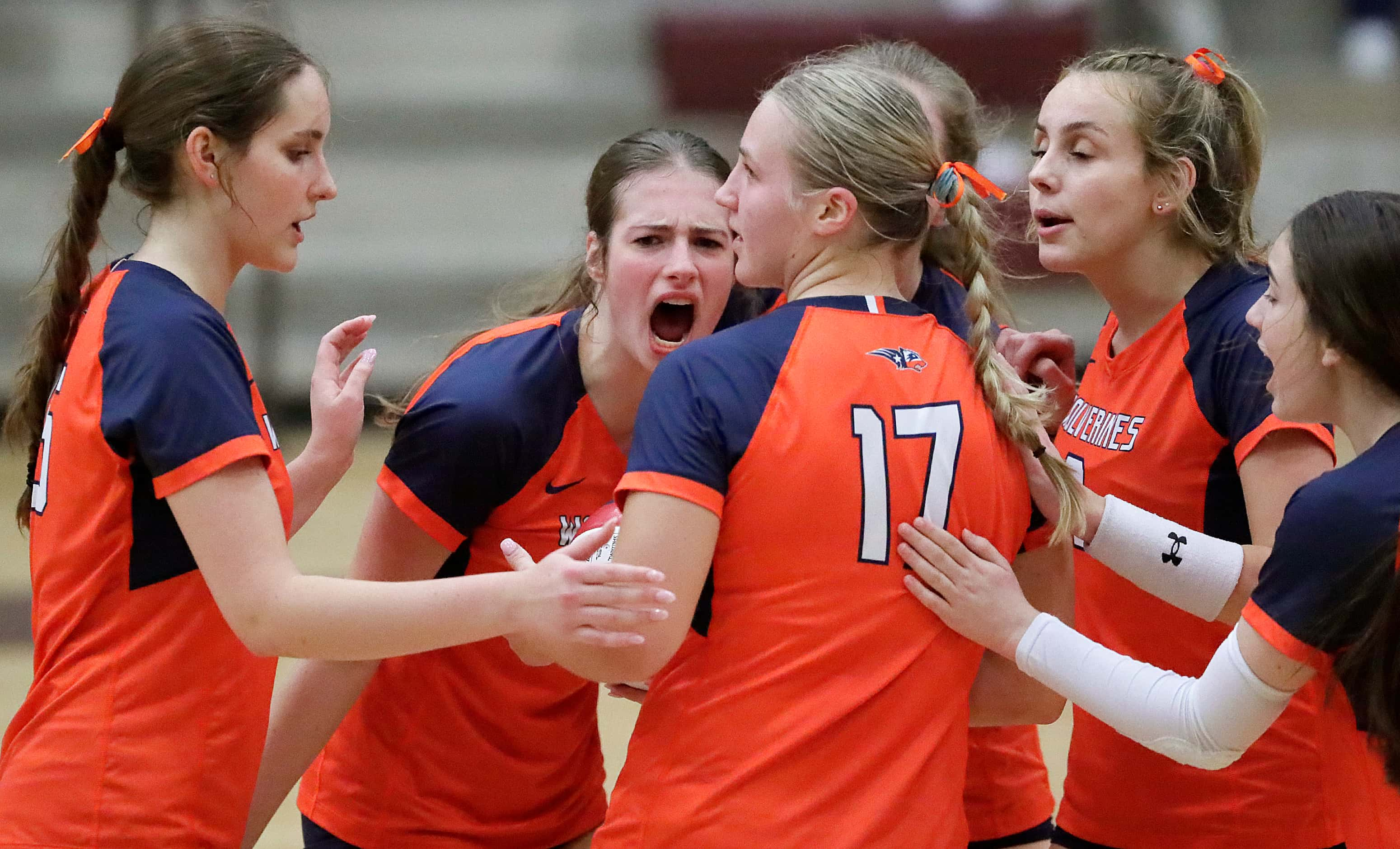 Wakeland High School outside hitter Kealakai Bandy (17) has her team rally around after...