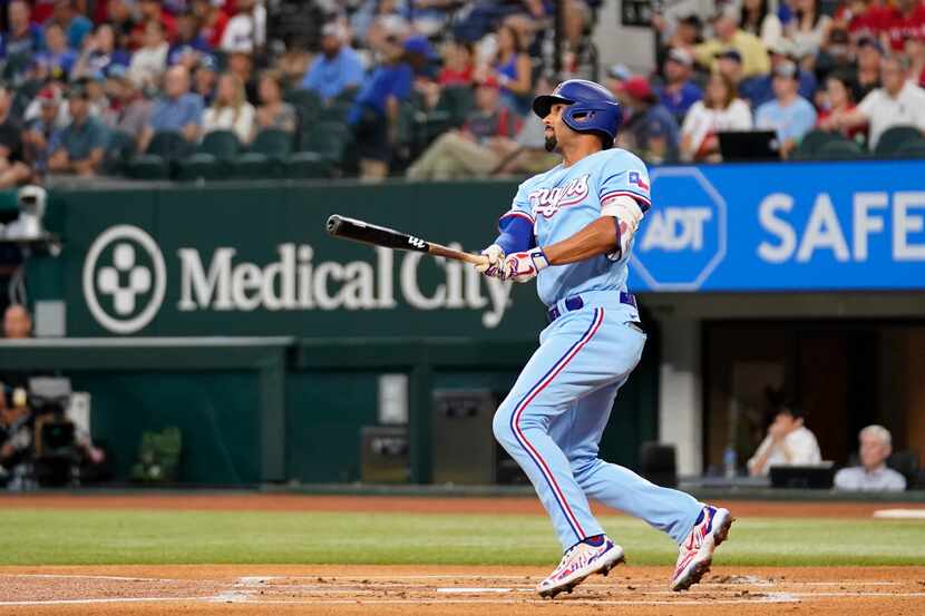 Texas Rangers' Marcus Semien watches the flight of his lead-off solo home run in the first...