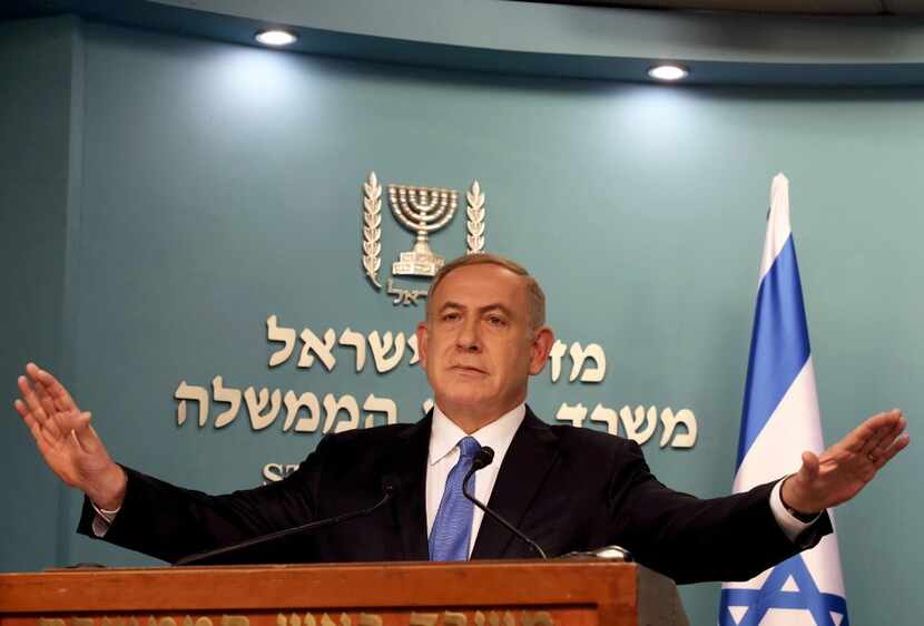 Israeli Prime Minister Benjamin Netanyahu gestures as he delivers a statement to the press...