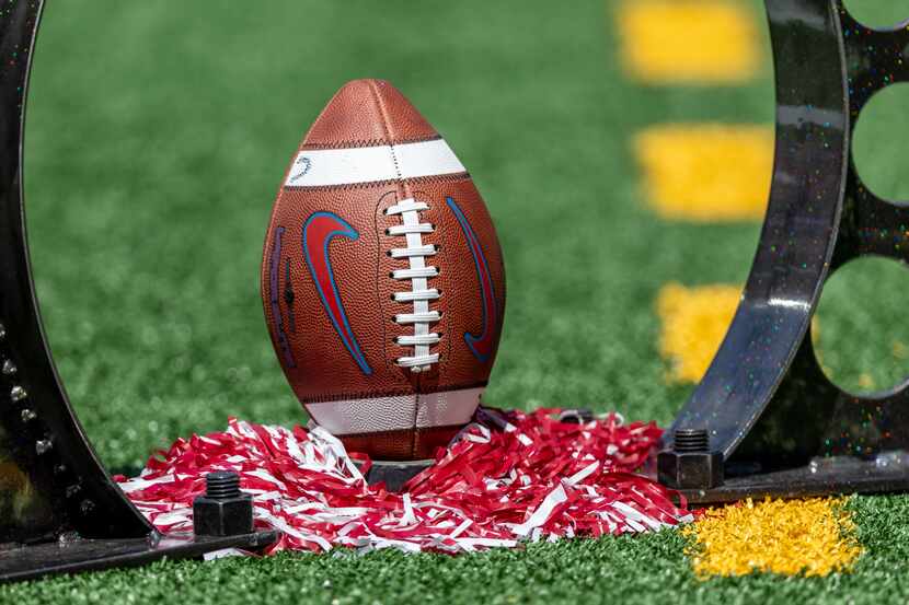 A football rests on the turf as a pregame prop for CBS before an NCAA college football game...