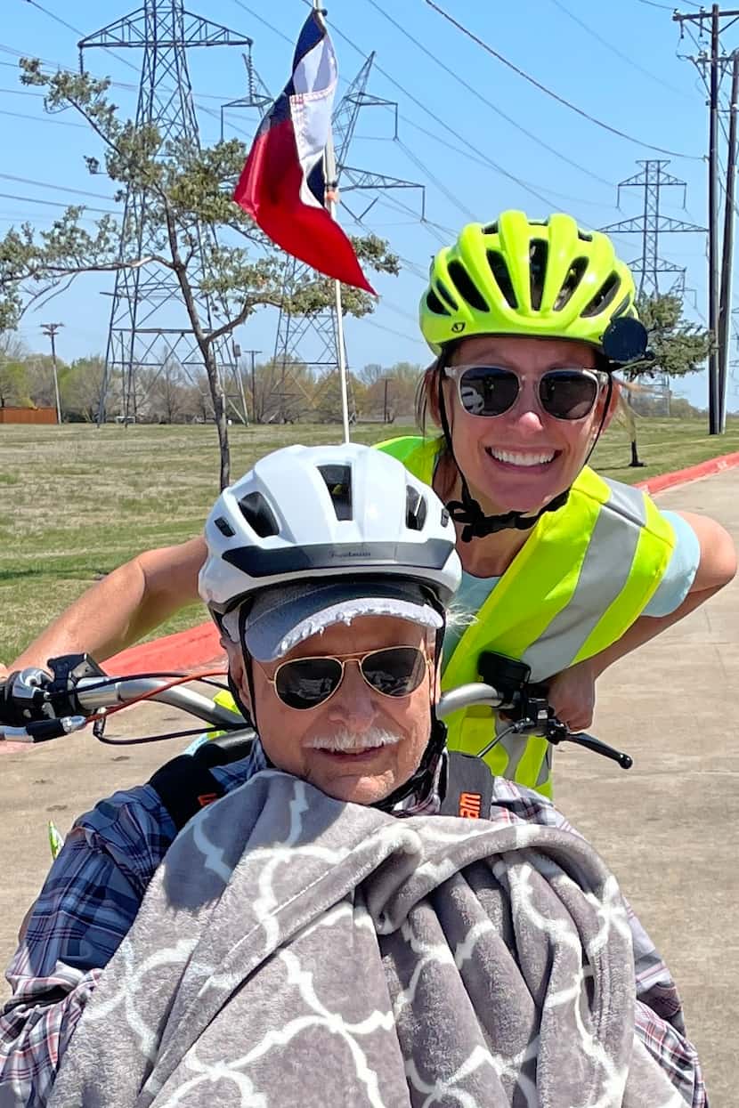 Shannon Catalano pushes a North Texas man in a wheelchair-adapted bike.