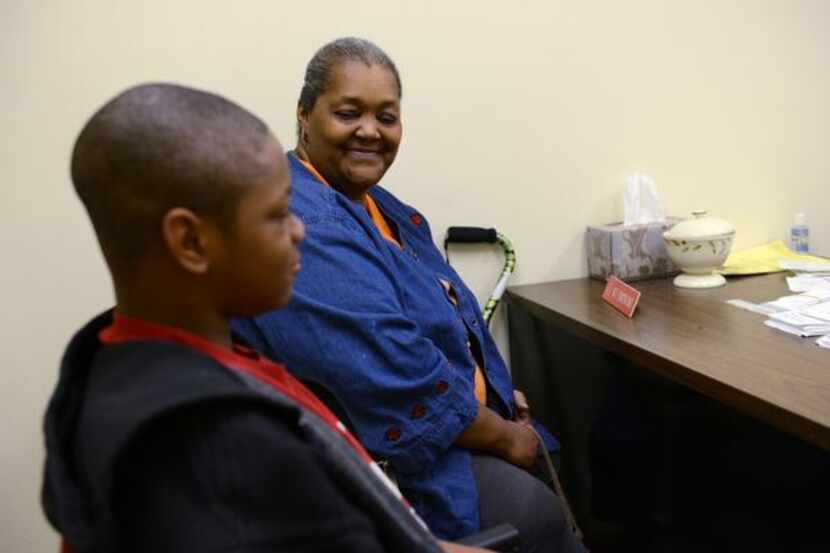 
Linda Wooten and her 11-year-old grandson LaDarrian Wooten attend an interview to receive...