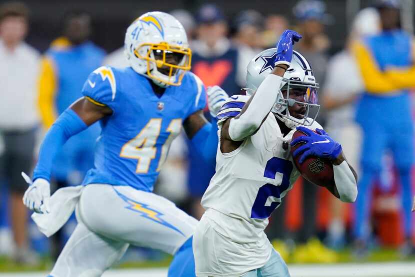 Dallas Cowboys' KaVontae Turpin, right, runs for a touchdown on a kick return during the...