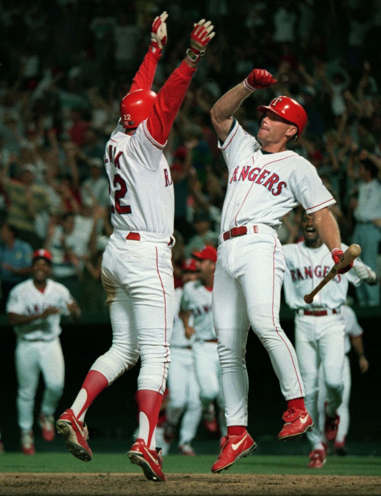 Rangers Will Clark (left) and Rusty Greer celebrate a walk-off win in the "Red Shoe'd...