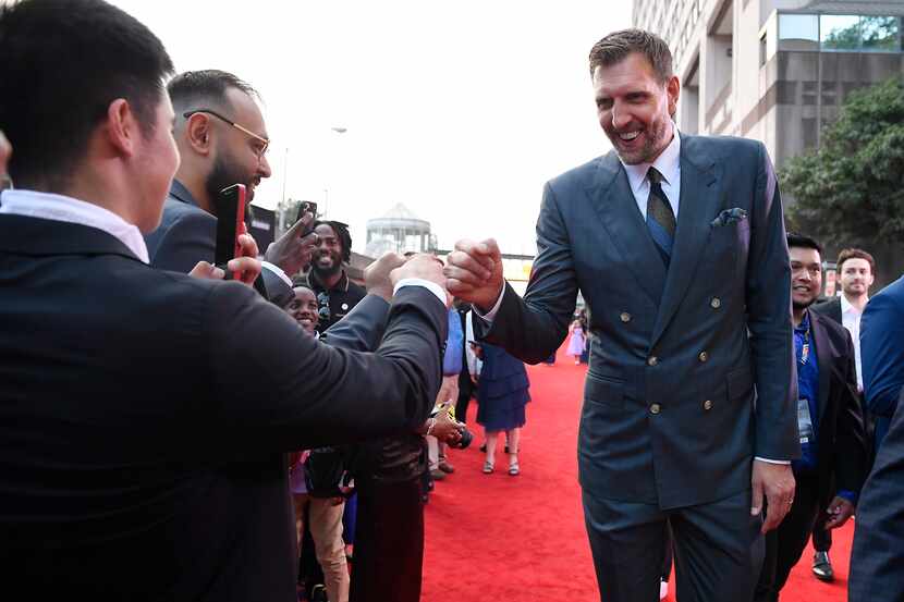 Dirk Nowitzki greets fans as he arrives on the red carpet for his enshrinement at the...