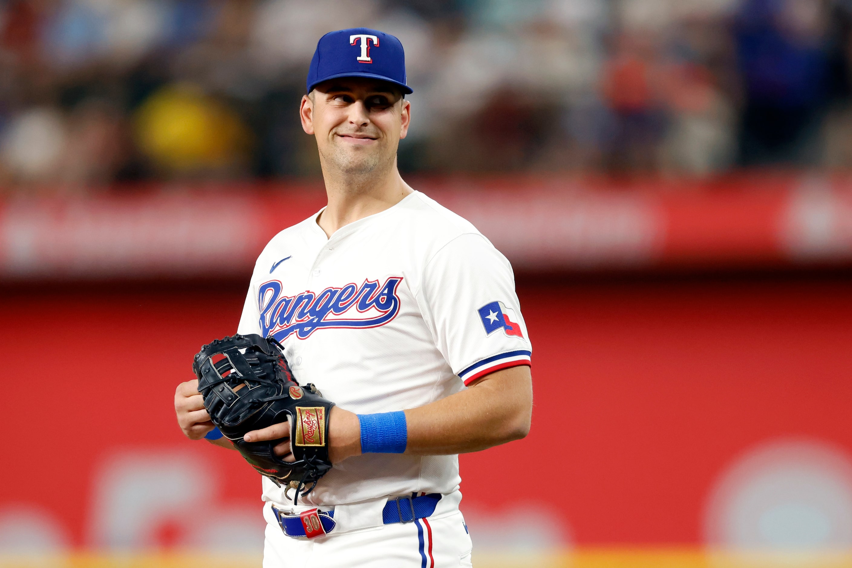 Texas Rangers first baseman Nathaniel Lowe (30) smiles as he talks with the Seattle Mariners...