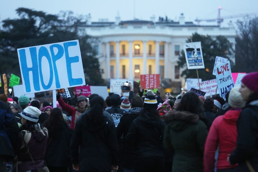 Protesters gather outside the White House at the finish of the Women's March on Washington...