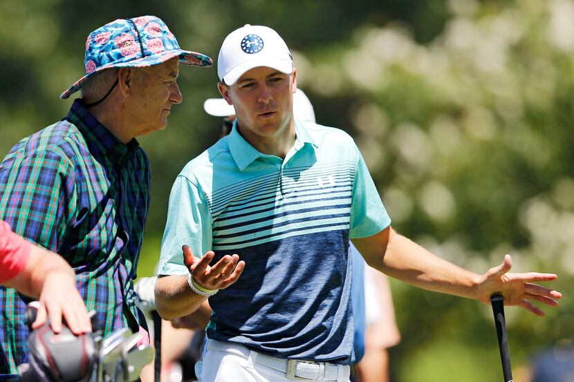Jordan Spieth talks with entertainer Bill Murray on the second hole during the Dean & DeLuca...