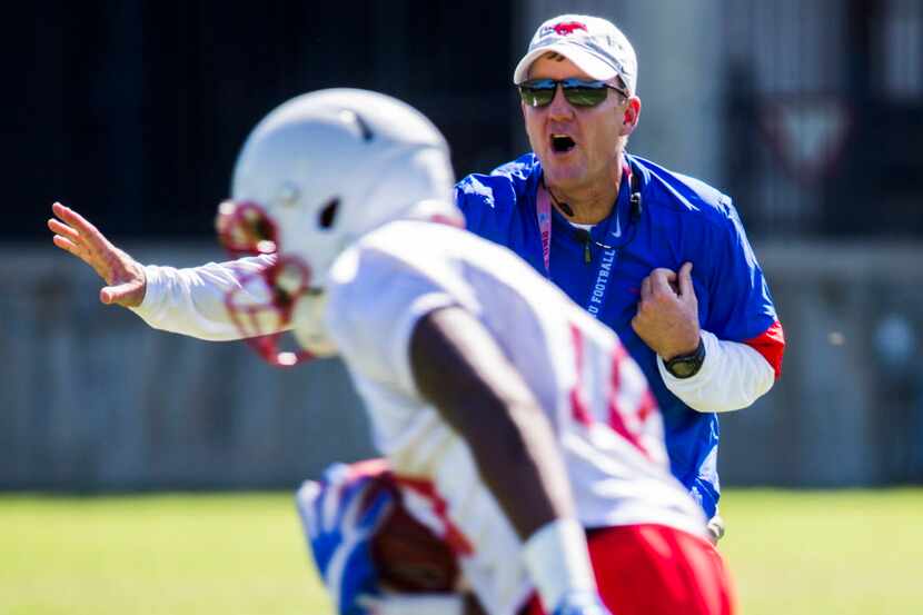 SMU head football coach Chad Morris yells at wide receiver Brandon Benson (10) while the SMU...