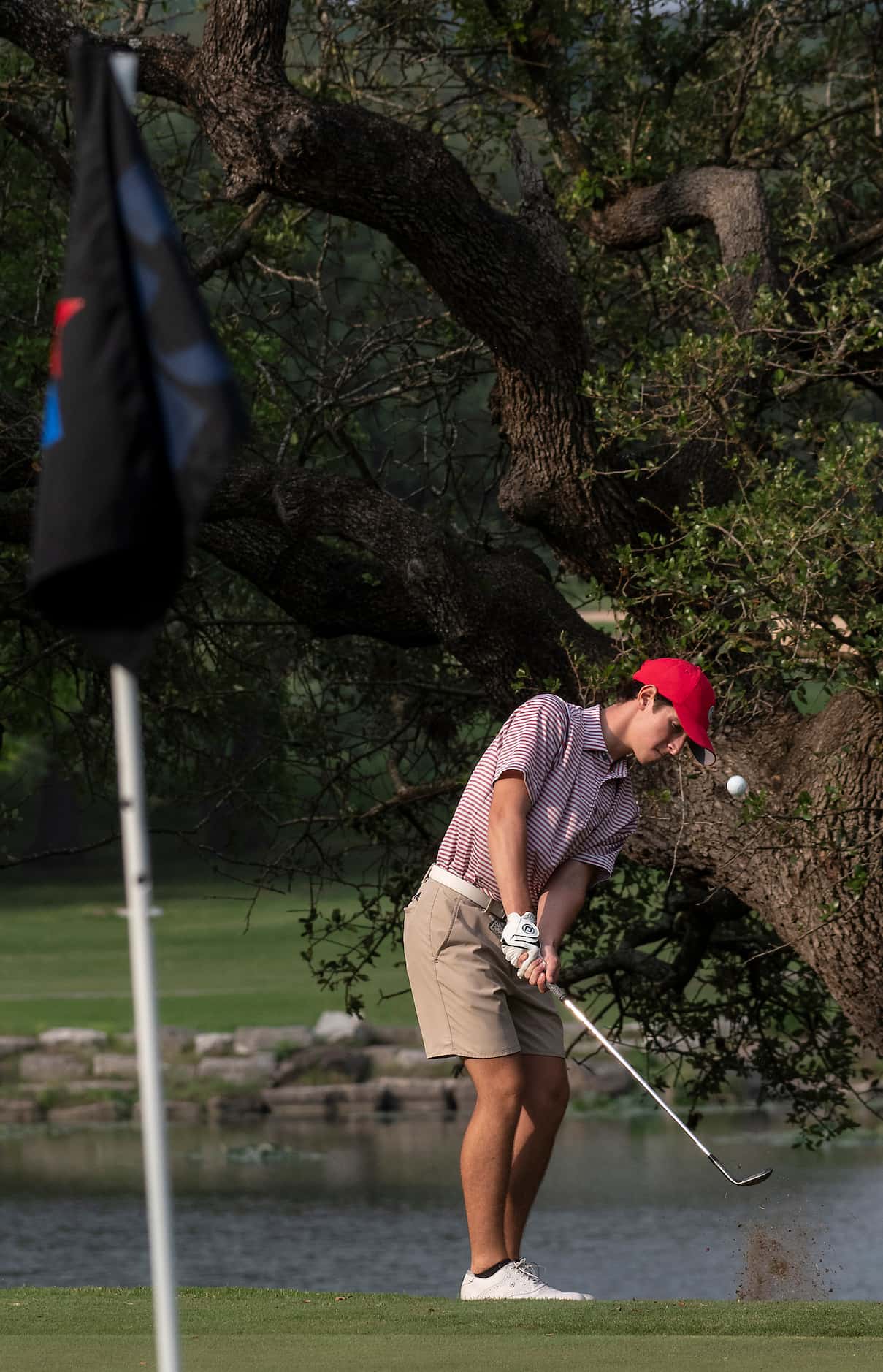 Flower Mound Marcus, Jack Kash, chips up onto the no1. green during the first round of the...