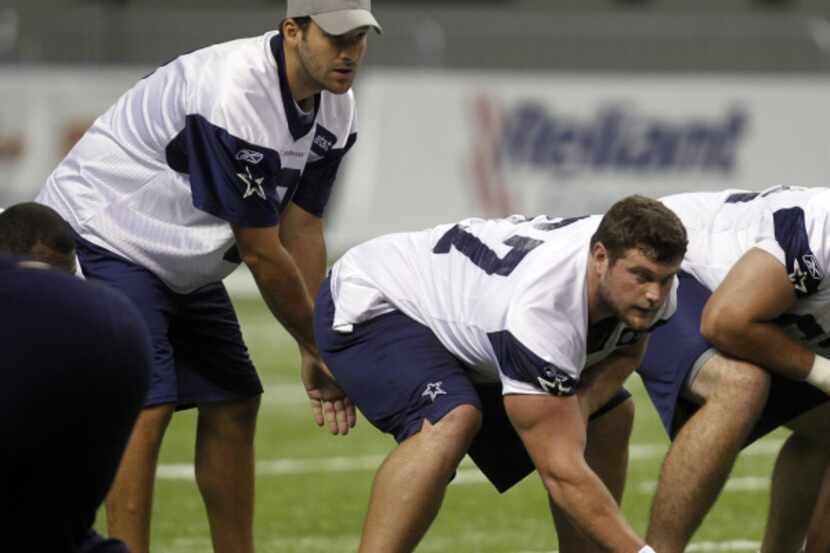 Dallas Cowboys Phil Costa (67) prepares to hike the ball to Tony Romo (9) during the morning...