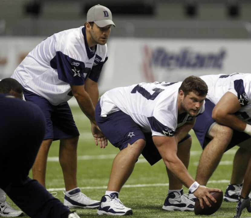 Dallas Cowboys Phil Costa (67) prepares to hike the ball to Tony Romo (9) during the morning...
