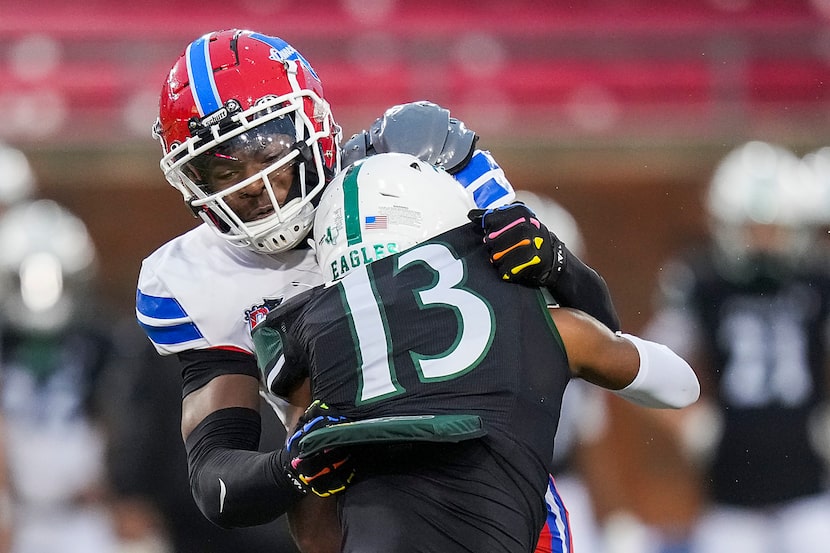 Duncanville linebacker Colin Simmons (8) wraps up Prosper’s Prentice Sanders (13) during the...