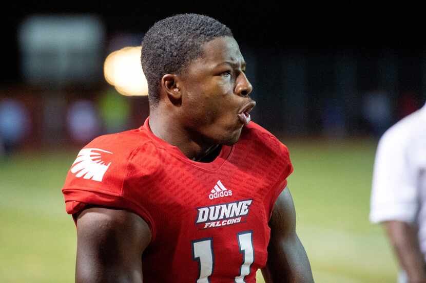 Bishop Dunne senior defensive back Brian Williams (11) reacts to hit by one of his teammates...