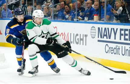 FILE - Stars defenseman Miro Heiskanen (4) controls the puck from Blues center Robert Thomas...