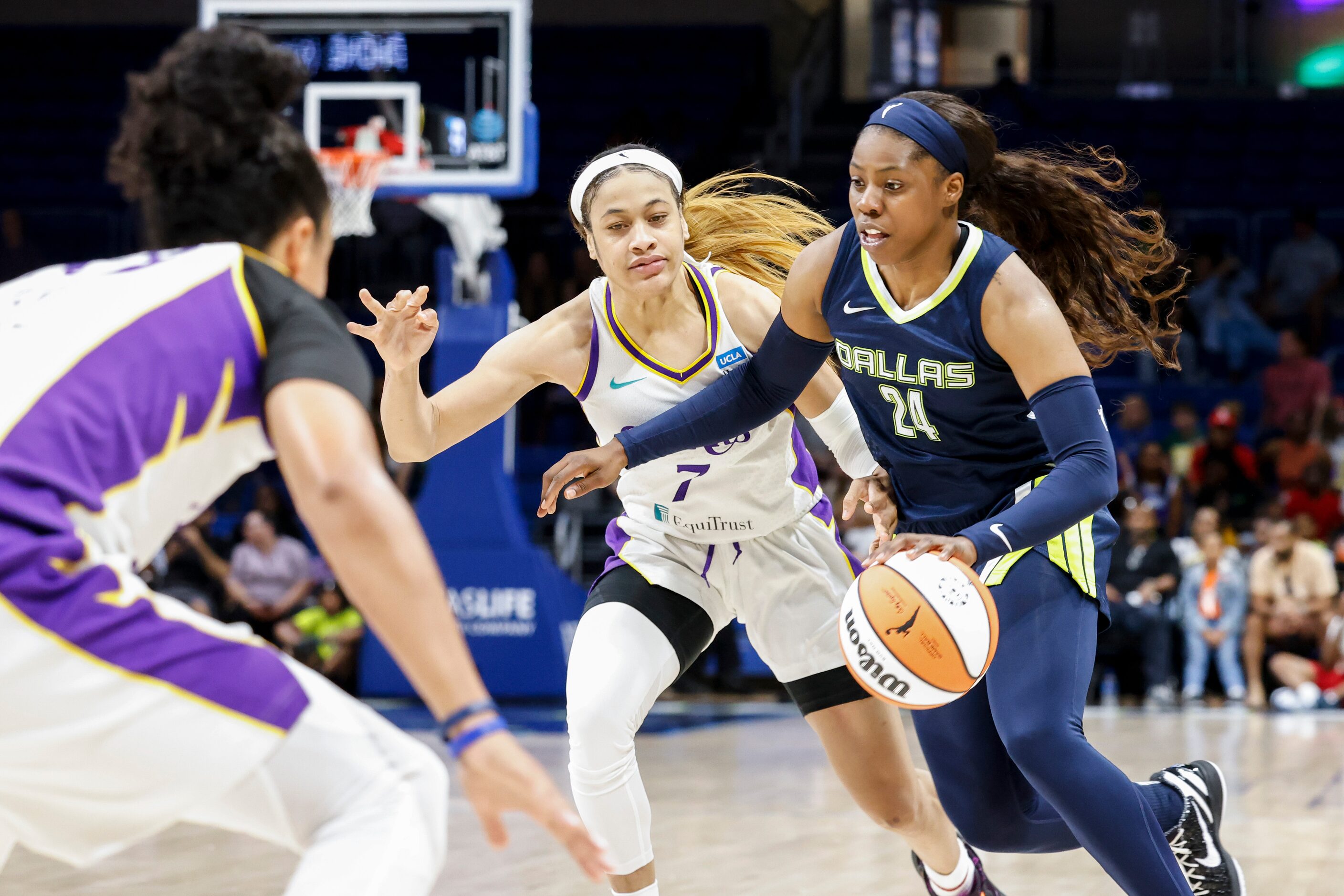 Dallas Wings guard Arike Ogunbowale (24) dribbles past Los Angeles Sparks guard Chennedy...