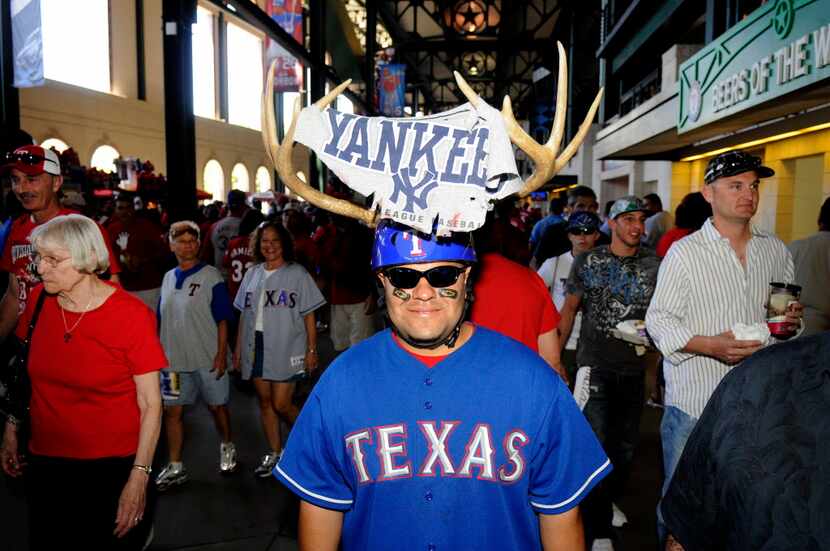 Lupe Diaz of Red Oak, displays his personalized antlers prior to the second game of the ALCS...