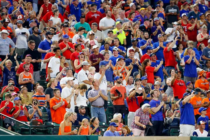 Texas Rangers fans cheer Texas Rangers Adrian Beltre's 2,999 hit in the fourth inning at...