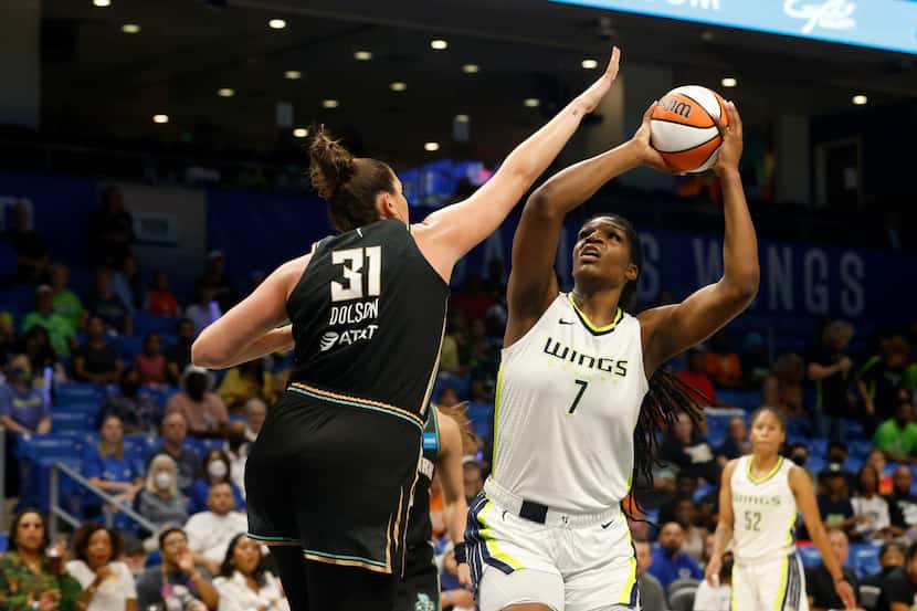 Dallas Wings center Teaira McCowan (7) shoots as she is defined by New York Liberty center...