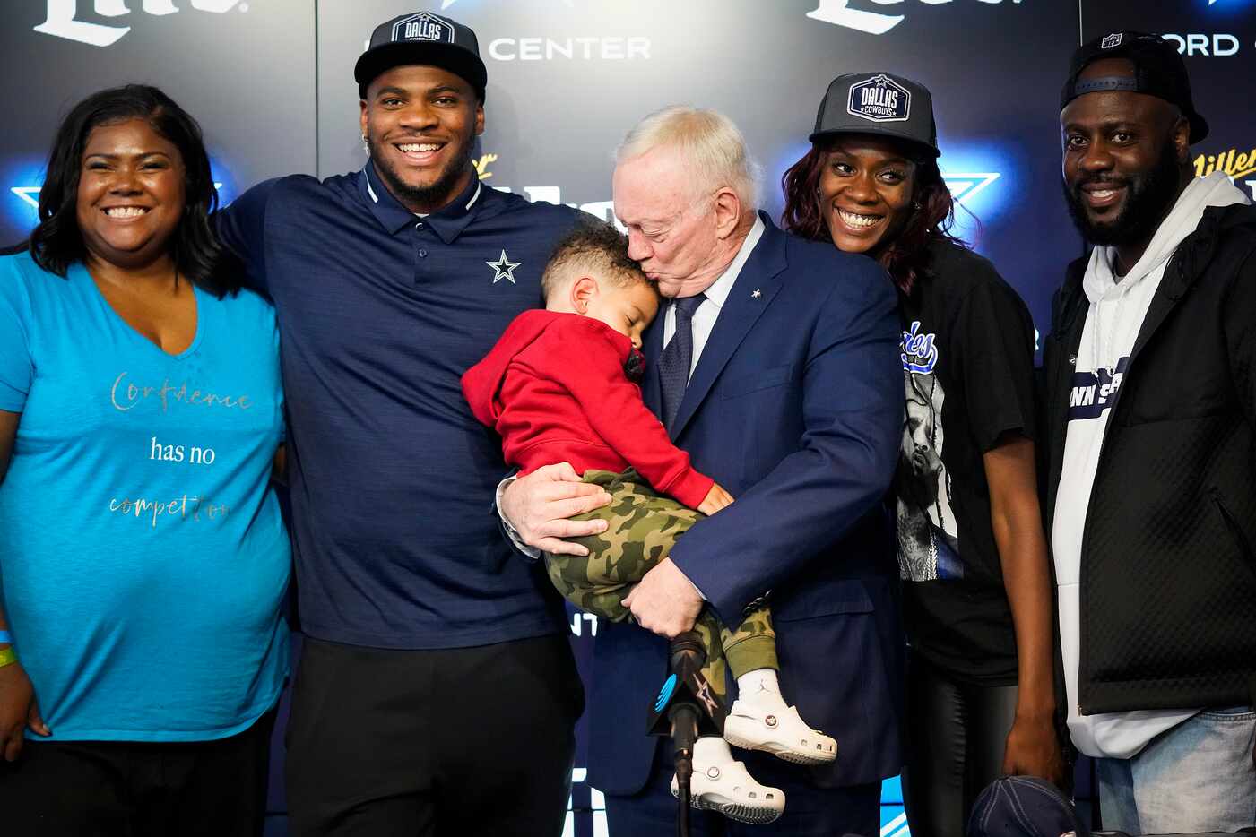 Dallas Cowboys owner Jerry Jones kisses Malcolm Parsons, 3, the son of first-round draft...