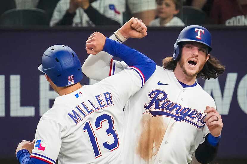 Texas Rangers outfielder Brad Miller celebrates with catcher Jonah Heim after hitting a...