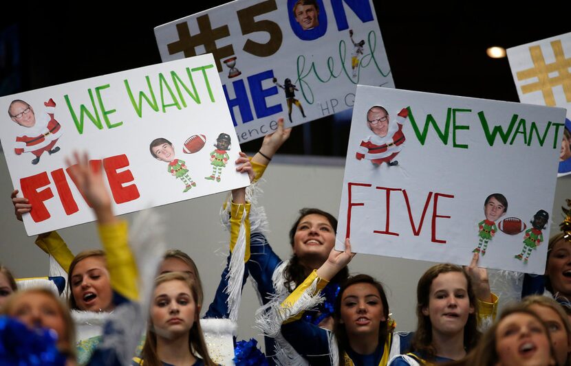 Members of the Highland Belles cheer for their team against McKinney North during the first...