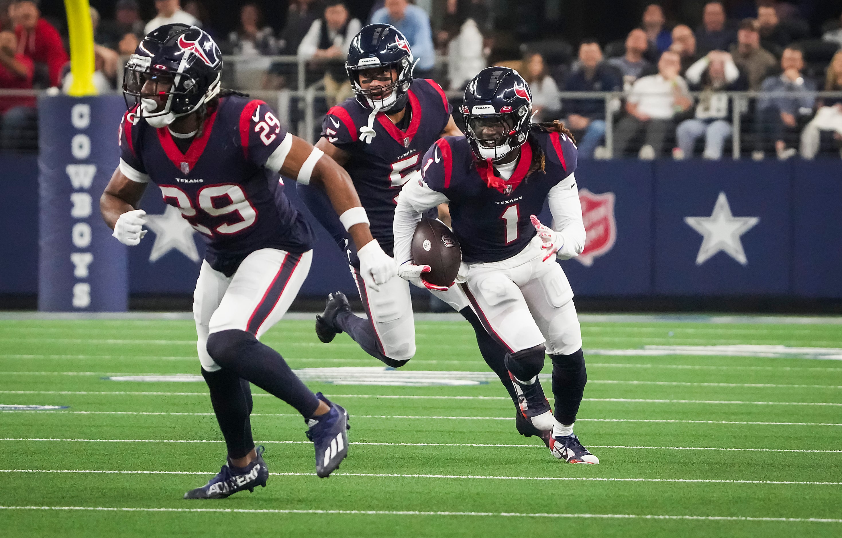 Houston Texans cornerback Tremon Smith (1) returns an interception during the first half of...