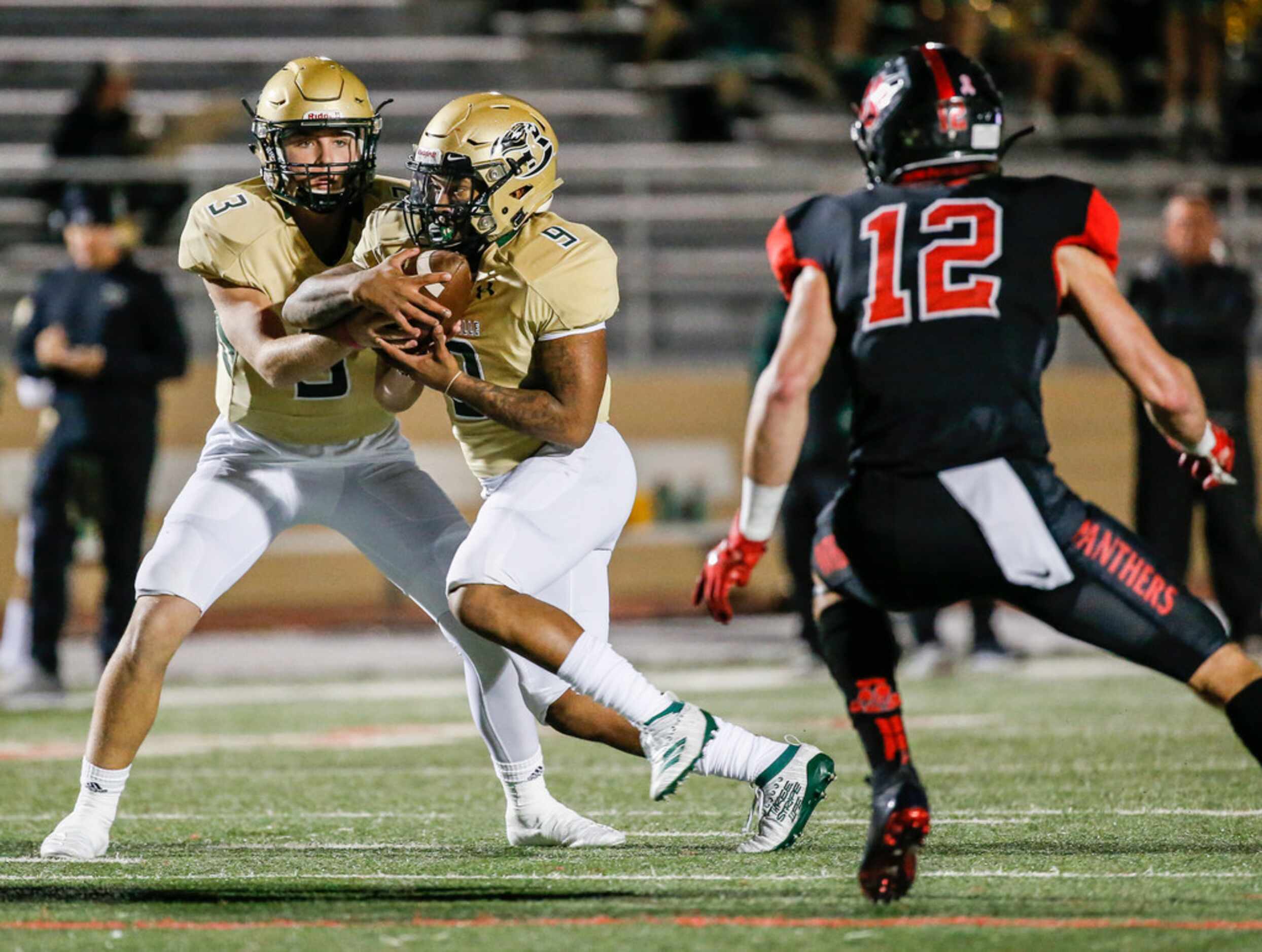 Birdville quarterback Stone Earle (3) hands off to running back Laderrious Mixon (9) as they...