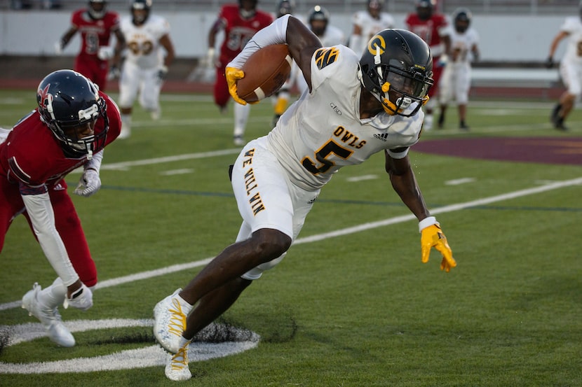 Garland High School wide receiver Jordan Hudson (5) powers through the defense during their...