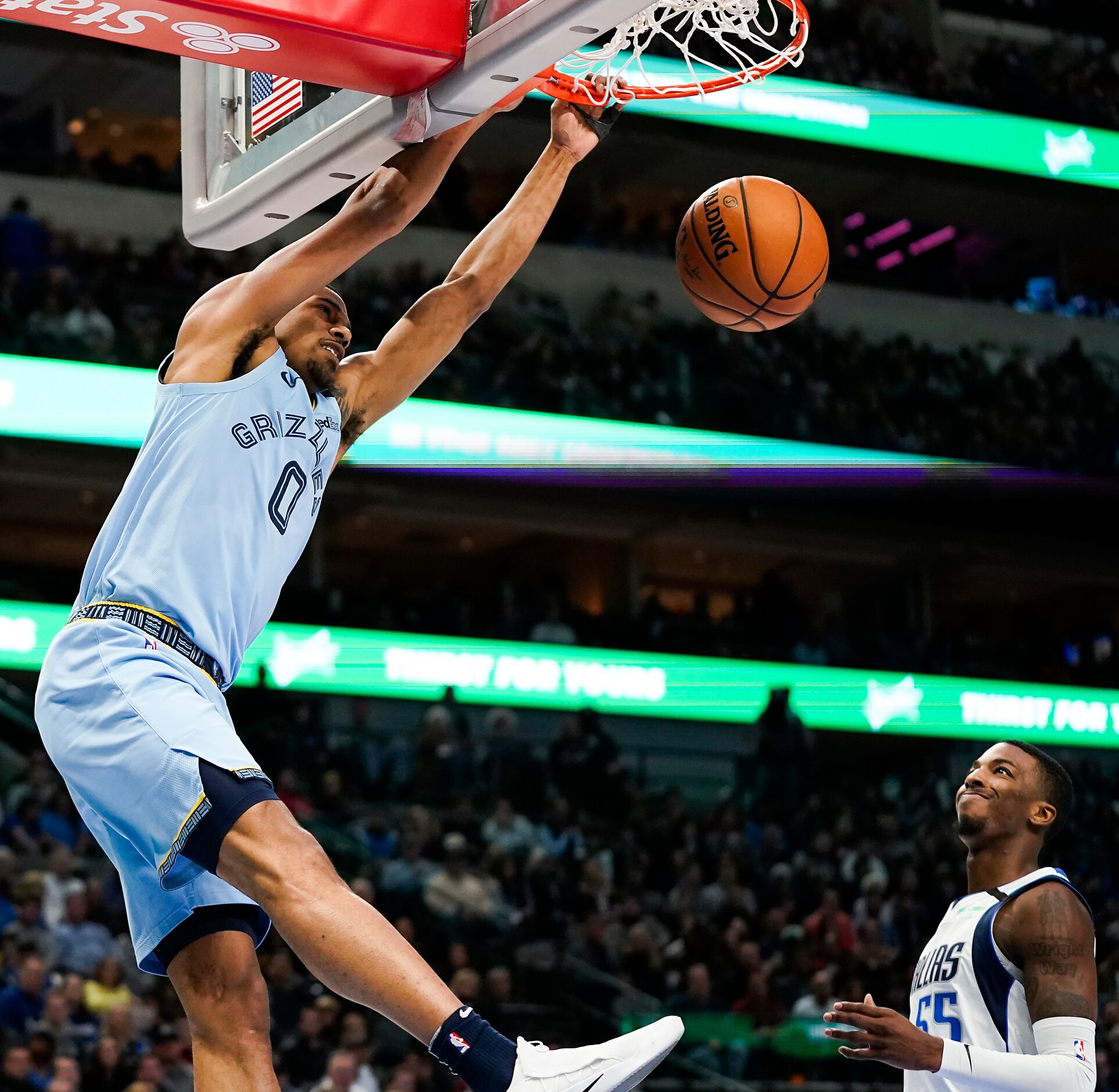 Memphis Grizzlies guard De'Anthony Melton (0) dunks the ball past Dallas Mavericks guard...