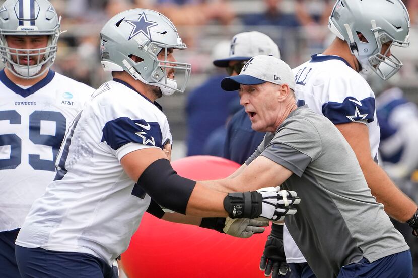 Dallas Cowboys guard Zack Martin (70) works with offensive line coach Joe Philbin during a...