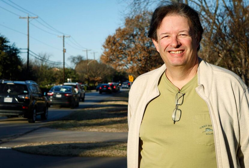 
Forest Hills resident Garrett Sherman stands in his front yard on Churchill Way, which he...