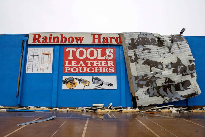 A large section of the roof at the Rainbow Hardware store hangs over the edge of the...