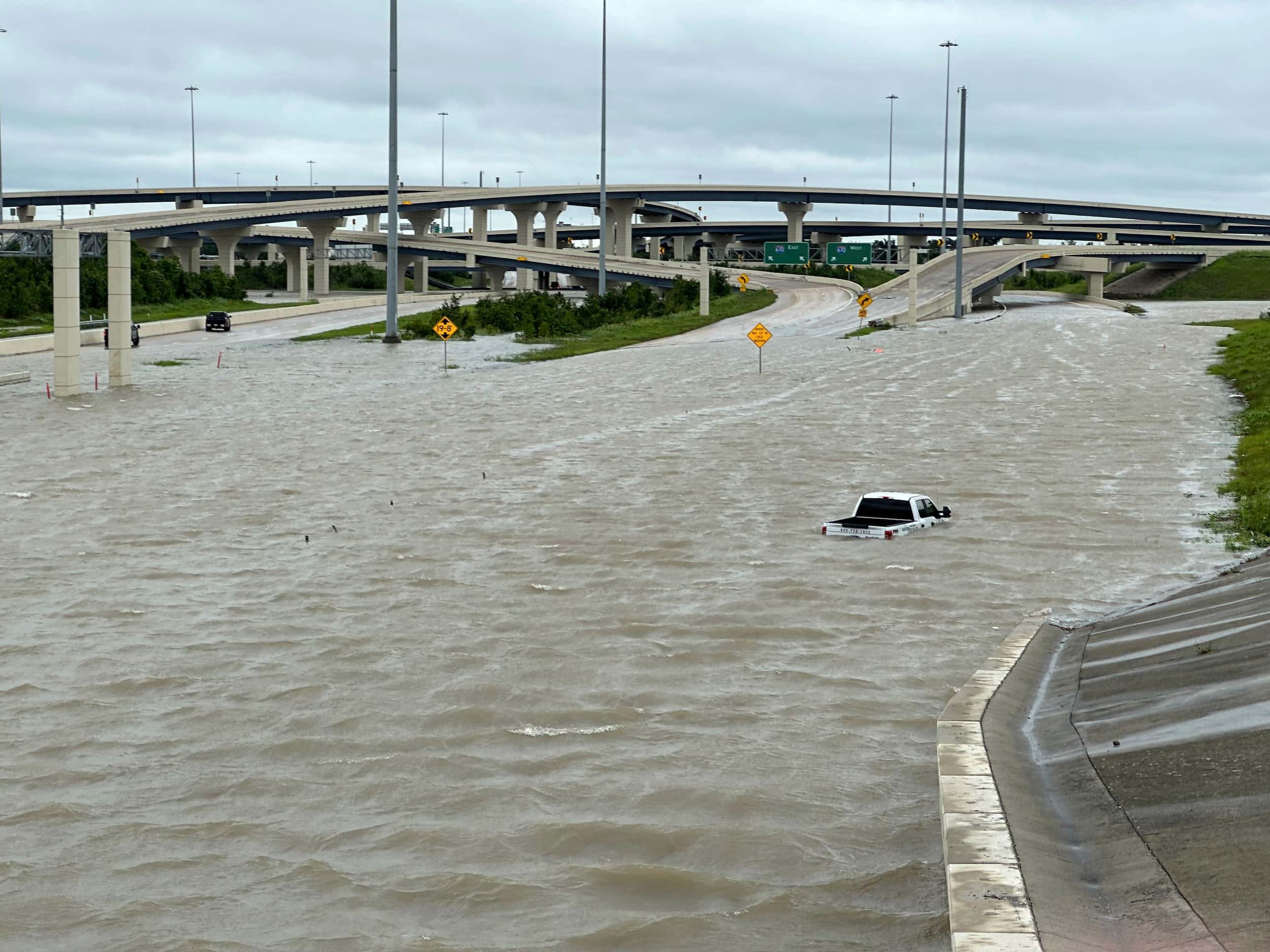 A vehicle is stranded in high waters on a flooded highway in Houston, on Monday, July 8,...