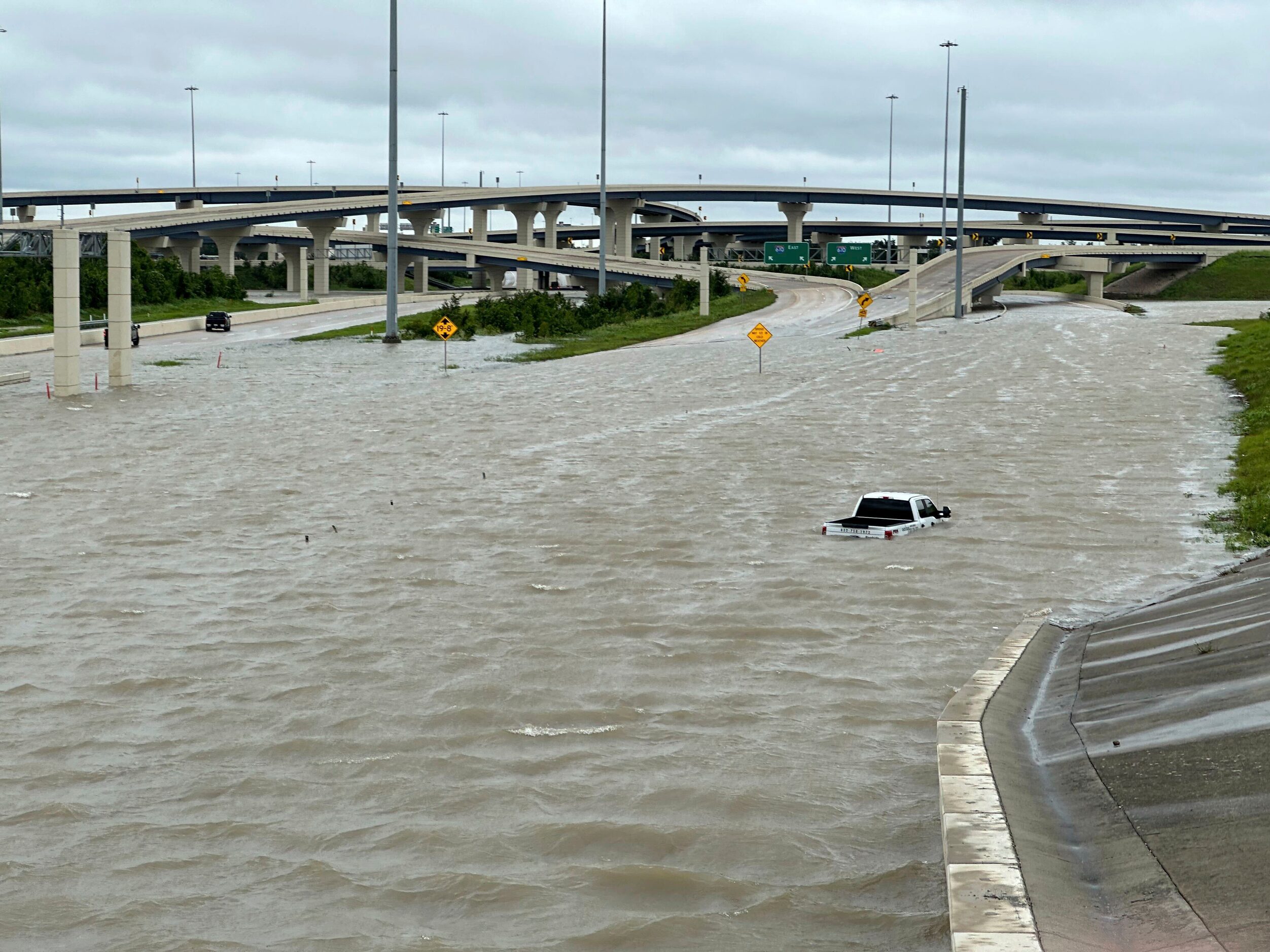 A vehicle is stranded in high waters on a flooded highway in Houston, on Monday, July 8,...