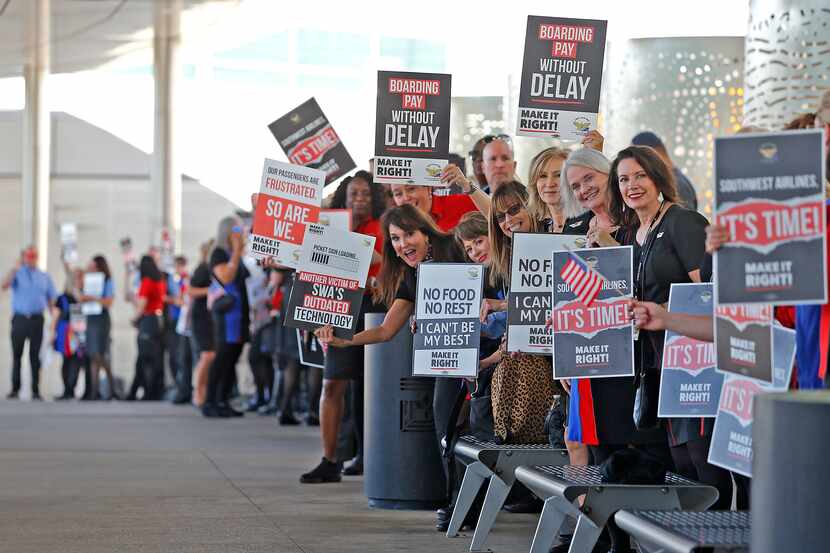Flight attendants and supporters of their union for Southwest Airlines protested outside of...