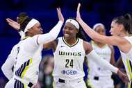 Dallas Wings' Odyssey Sims (2), Arike Ogunbowale (24) and Sevgi Uzun, right, celebrate in...