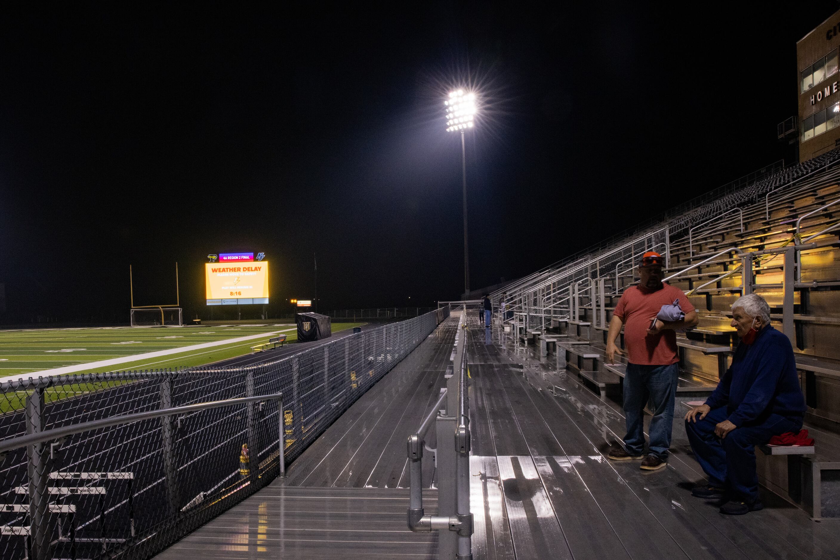 Fans sit in the stands during the weather delay before the Celina against Palestine boys...