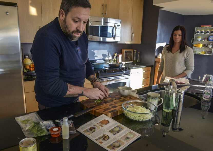 Chef Mike Isabella and his wife, Stacy Isabella, prepare a meal sent to him by Blue Apron,...
